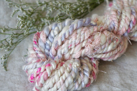 handspun yarn in soft whites, pinks and blues