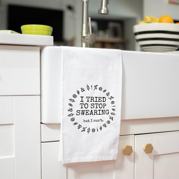 Flour sack towel that reads: I Tried To Stop Swearing But I Cun't