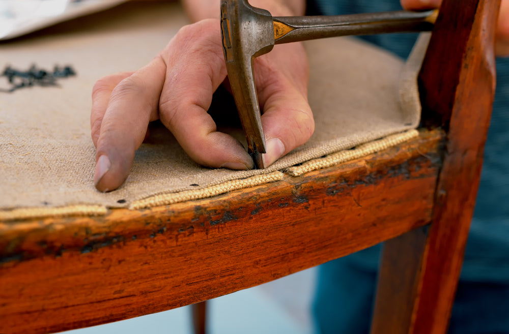 craftsman restoring antique chair