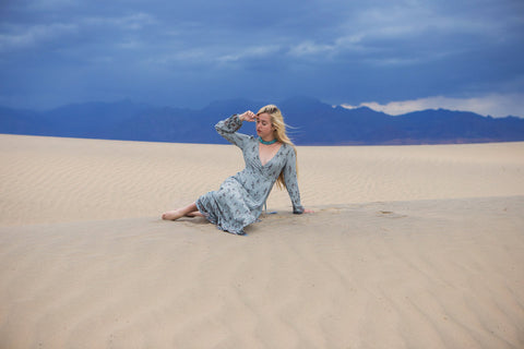 Astrobandit wearing Dreamers and Drifters grey wrap dress in the sand