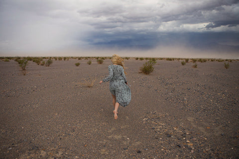 Astrobandit wearing Dreamers and Drifters grey wrap dress running death valley