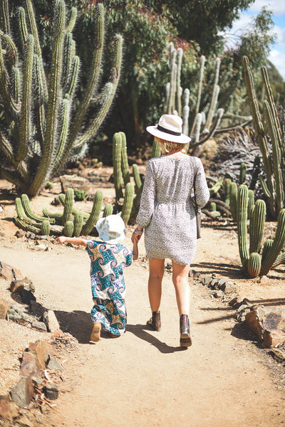 Verity, Head Designer of Dreamers & Drifters, in long sleeve babydoll dress Cheetah at Cactus Country