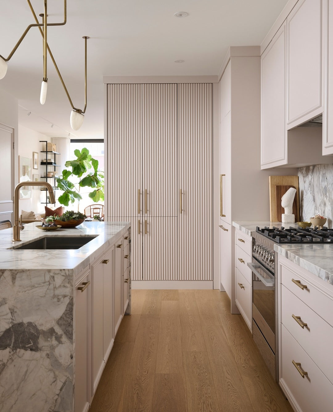 11. Soft Blush and Brass Elegance with Marble Drama (classic kitchen ideas)