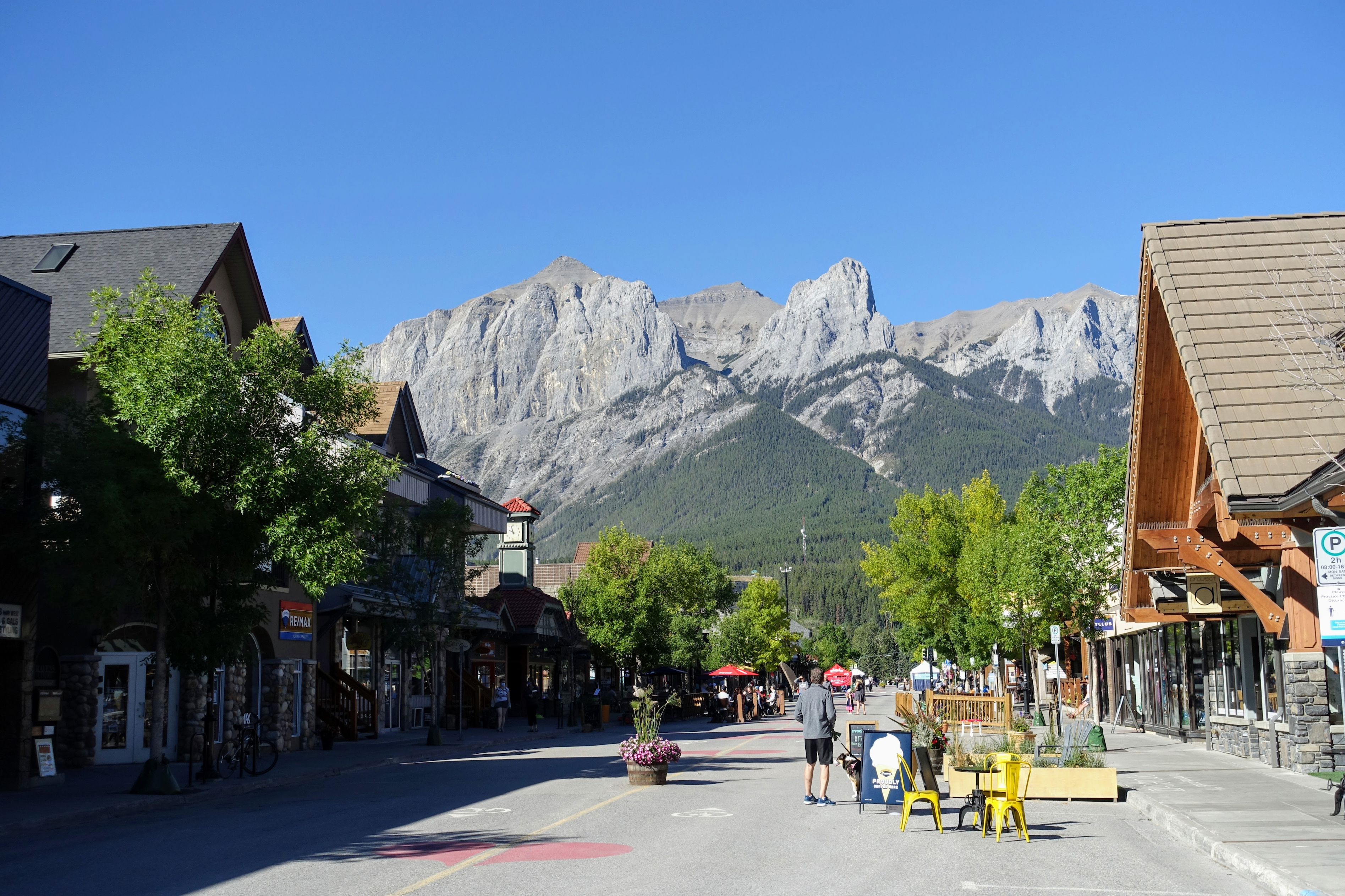 2. Canmore - Best for Families - A view of the main street with the mountains in the background during a beautiful summer day in Canmore, Alberta, Canada.