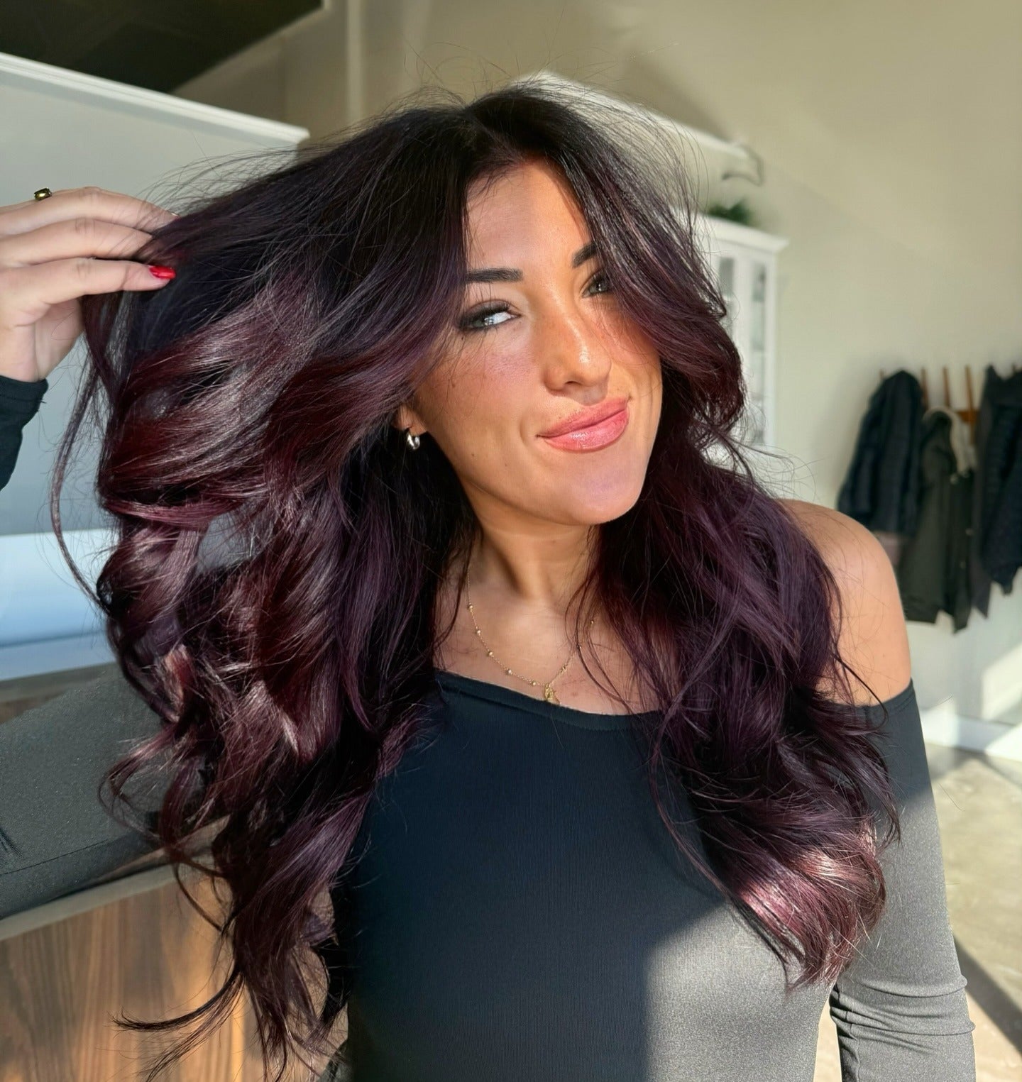 7. Volumized Plum Blowout with Curtain Layers (Plum Hair Color)