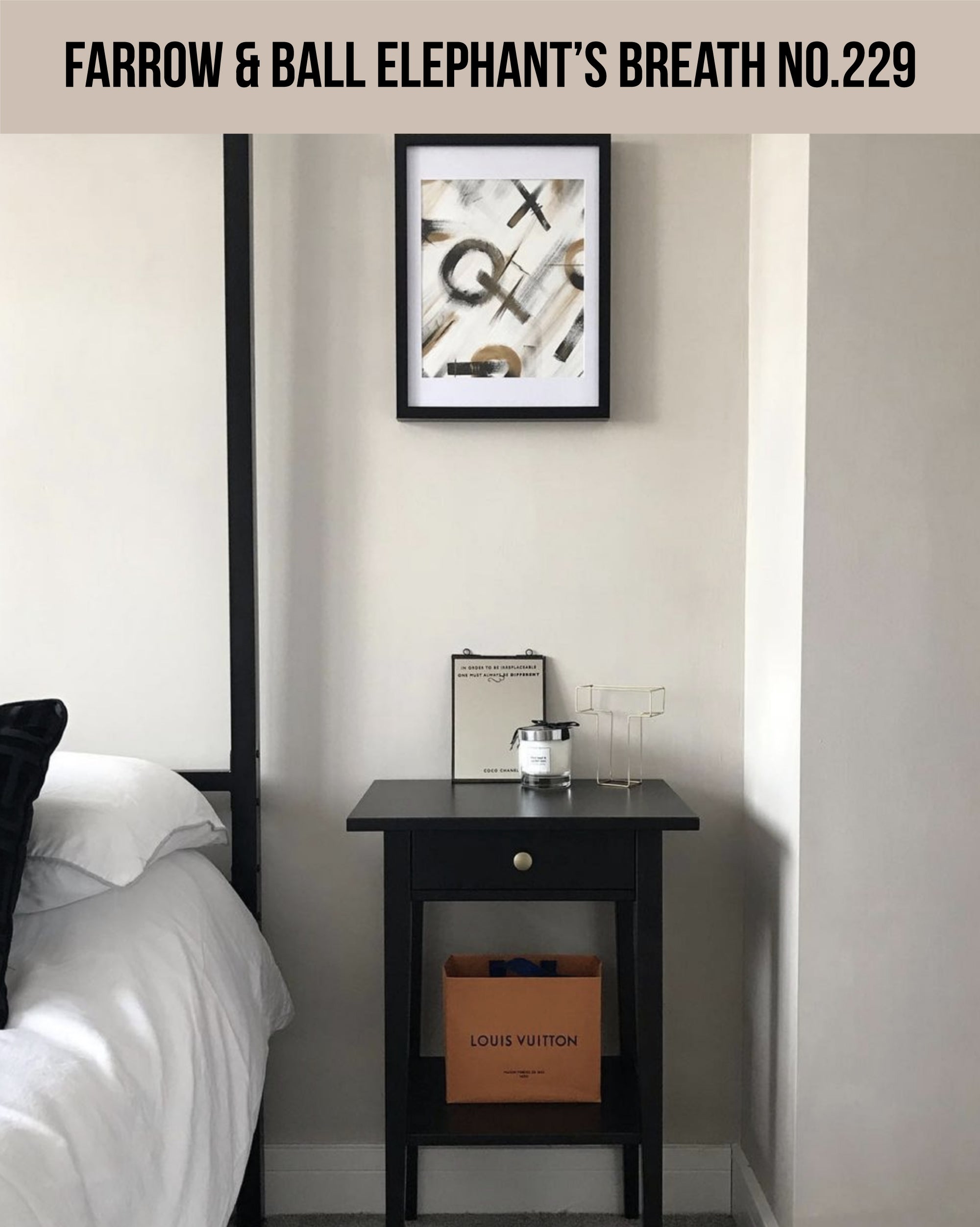 A black end table with a picture on the wall (Farrow & Ball Elephant’s Breath No.229)