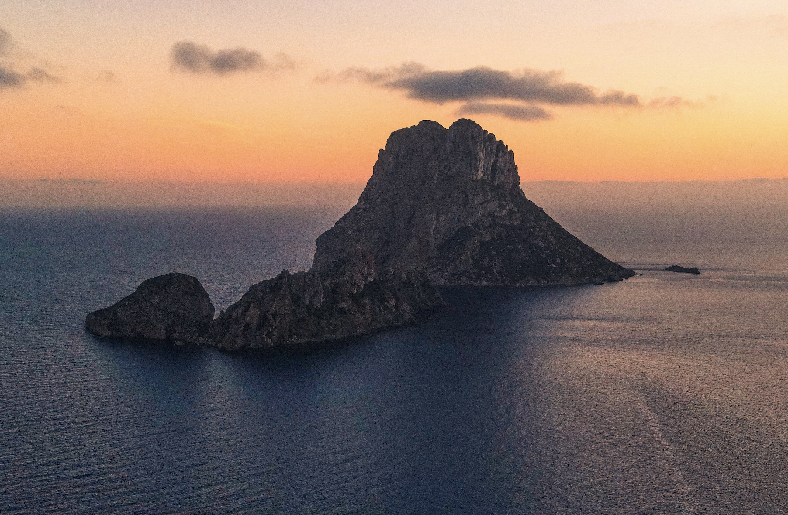 What months mark the peak season for visiting Ibiza?