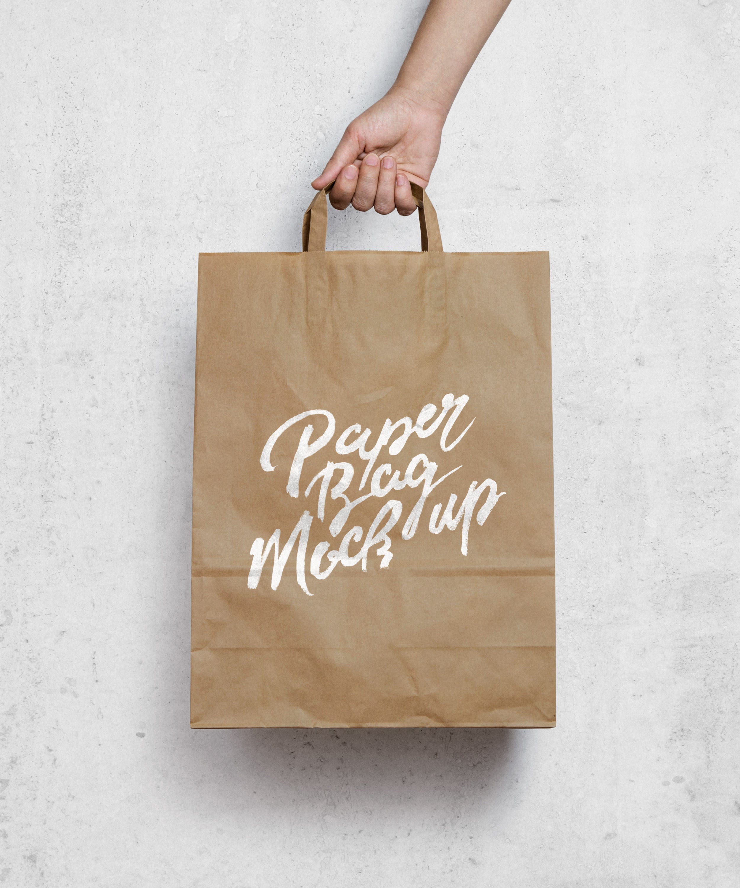 Download Free Hand Holding a Brown Paper Bag MockUp - CreativeBooster