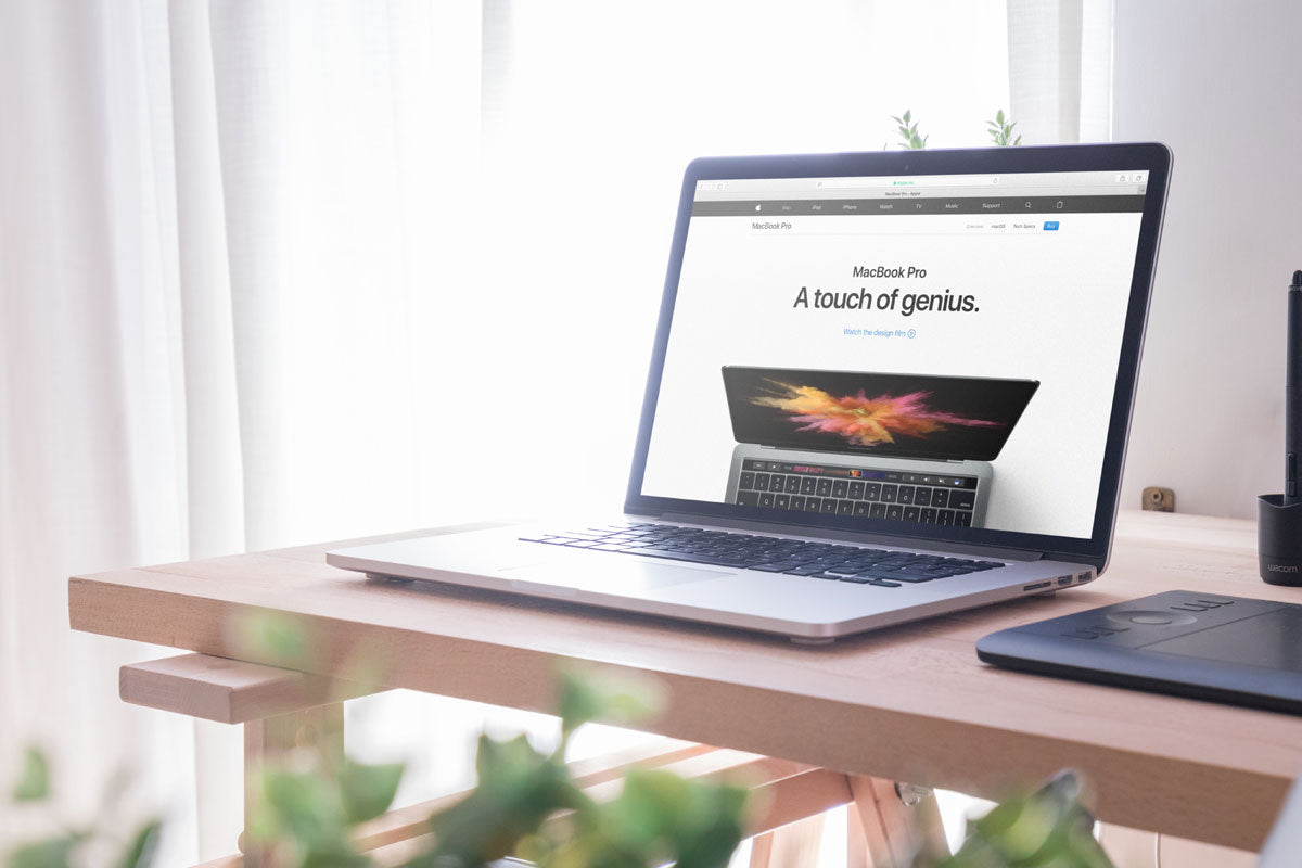 Download Free Macbook Pro Mockup on Office Desk - CreativeBooster