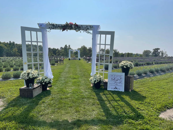 lavender farm wedding venue with wooden white door isle and alter.
