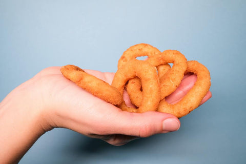 hand holding onion rings