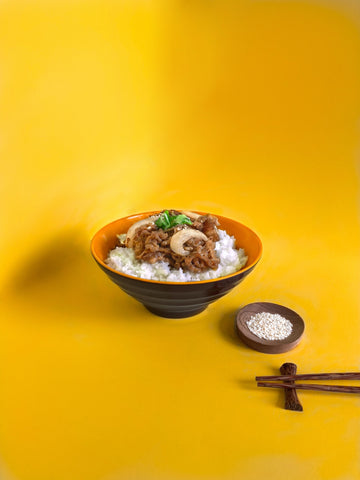 a bowl of rice with beef
