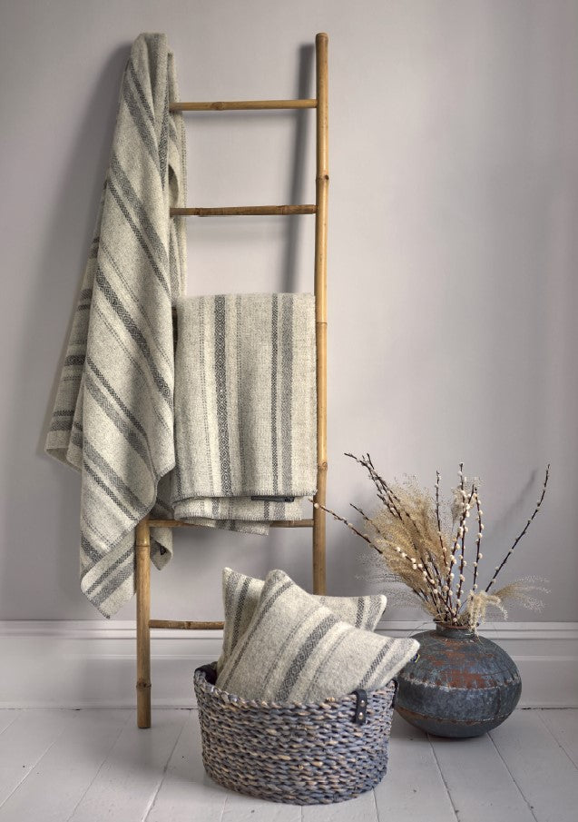 wood ladder with 100 percent british wool throws blankets and cushions by The British Blanket Company