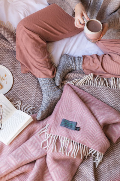 Cosy bed flatlay with socks pyjamas and blankets