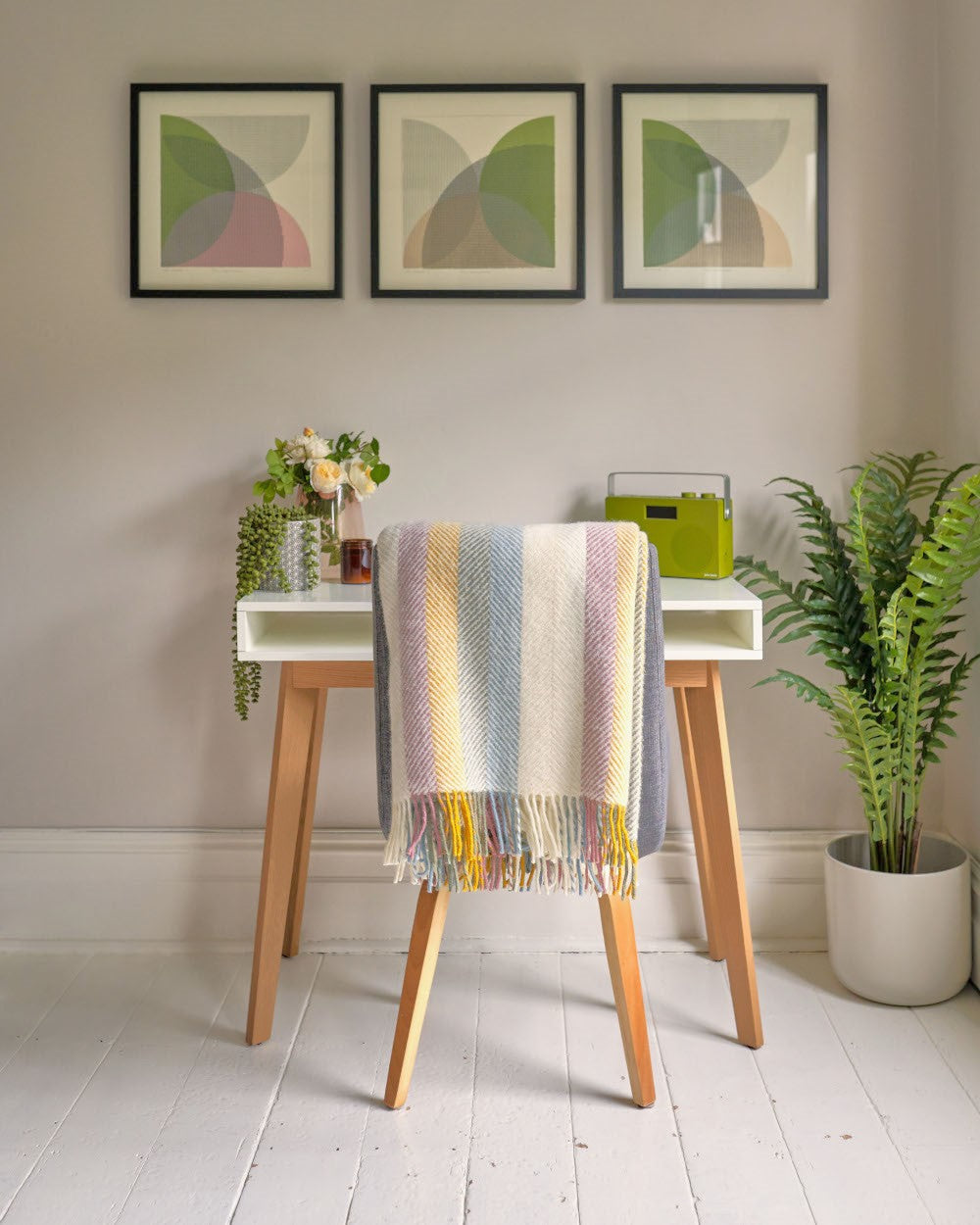 contemporary desk set up with a chair draped in a pastel rainbow stripe wool blanket from The British Blanket Company