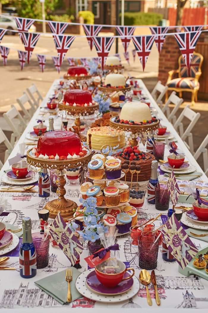 queens jubilee street party table set with a vast array of british food jellies and decorations in red white and blue