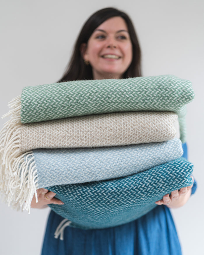 stack of blue and green wool throw blankets from The British Blanket Company