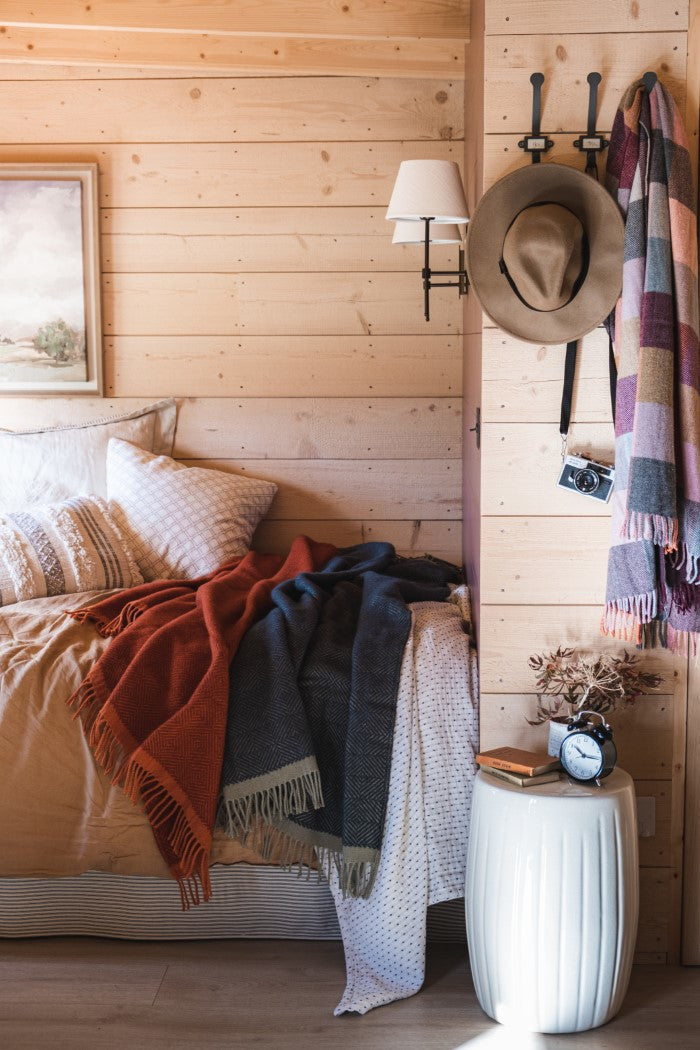 the british blanket company nature inspired decor wood cabin with Wildweave natural wool blankets on bed