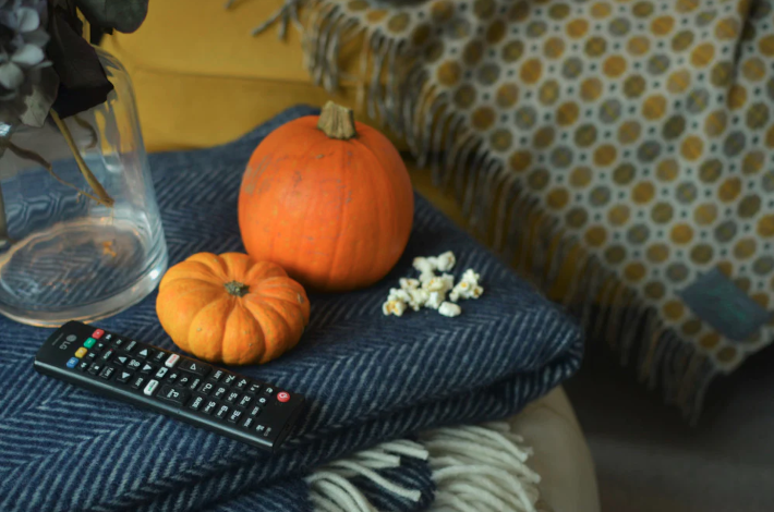 cosy movie night scene with navy blue wool blanket and pumpkins