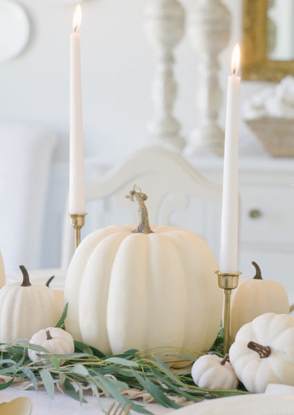 neutral halloween table decor white pumpkins and eucalyptus