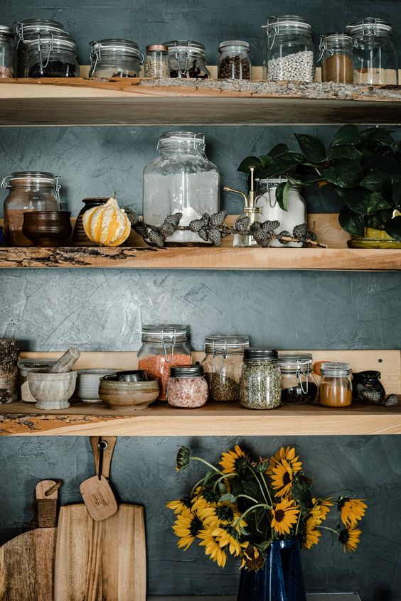 open shelves in kitchen with jars and rustic tableware