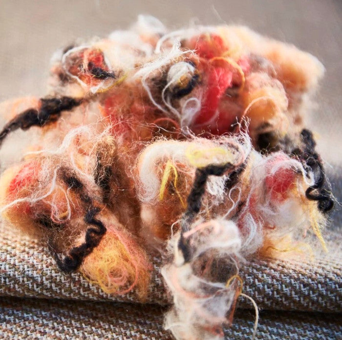 ball of recycled wool fibres in warm colours