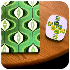 Green 1970s Op Art Placemat next to a vintage mid century coaster on a wooden table.