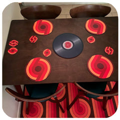 Customer photo of 70s Supergraphic placemats and coasters on a table with matching rug underneath