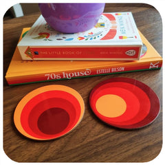 Customer photo of 70s Circles coasters on coffee table next to a stack of retro books