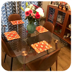customer photo orange op art place mats on glass table with scandi curtains