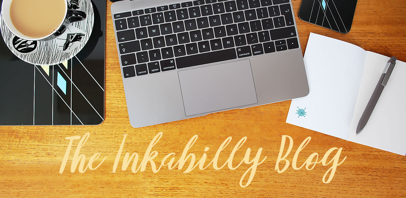 The Inkabilly Blog. Laptop, notebook & pen, vintage tea cup, retro placemat and coaster