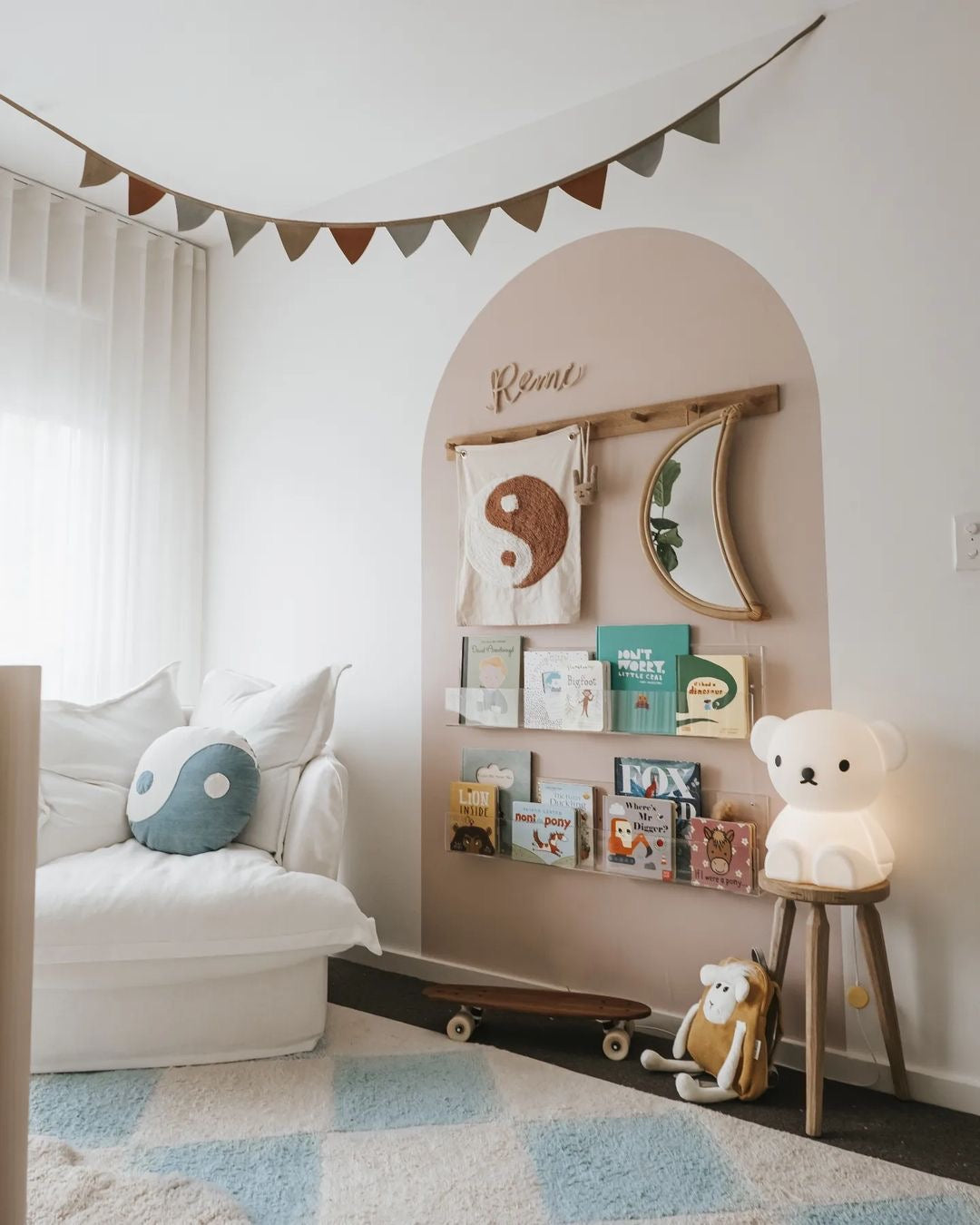 Soft blue nursery nook with comfortable white chair