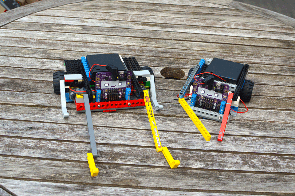 An image of two LEGO robots on a wooden table