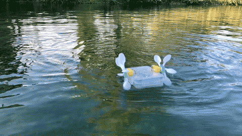 A GIF of a paddle boat being driven in a lake.