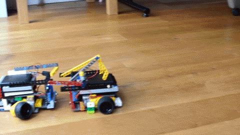 A GIF of two LEGO battling, where one robot crushes the other robot to pieces