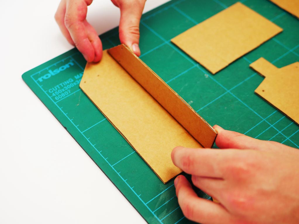 Image shows cardboard shapes cut out and central crane feature being folded.
