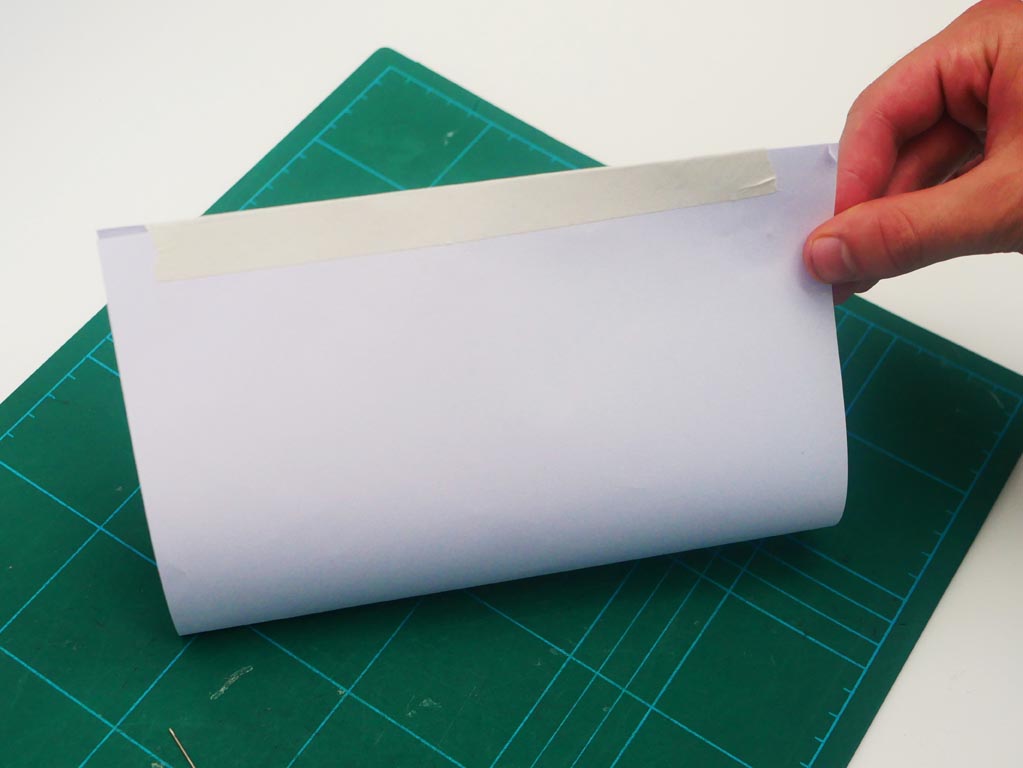 Image shows a4 paper folded in two and sealed with Sellotape.