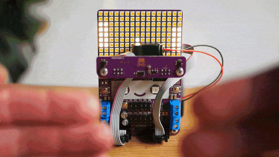 Animated gif showing pong being played on Smaeribot LED matrix by moving hands nearer and further away from distance sensors