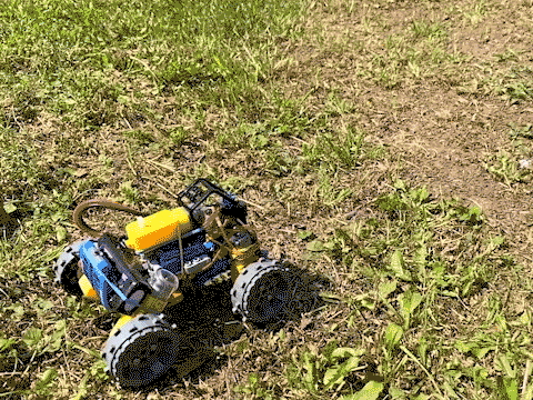 Looping video of a LEGO off-roader doing a wheelie on grass
