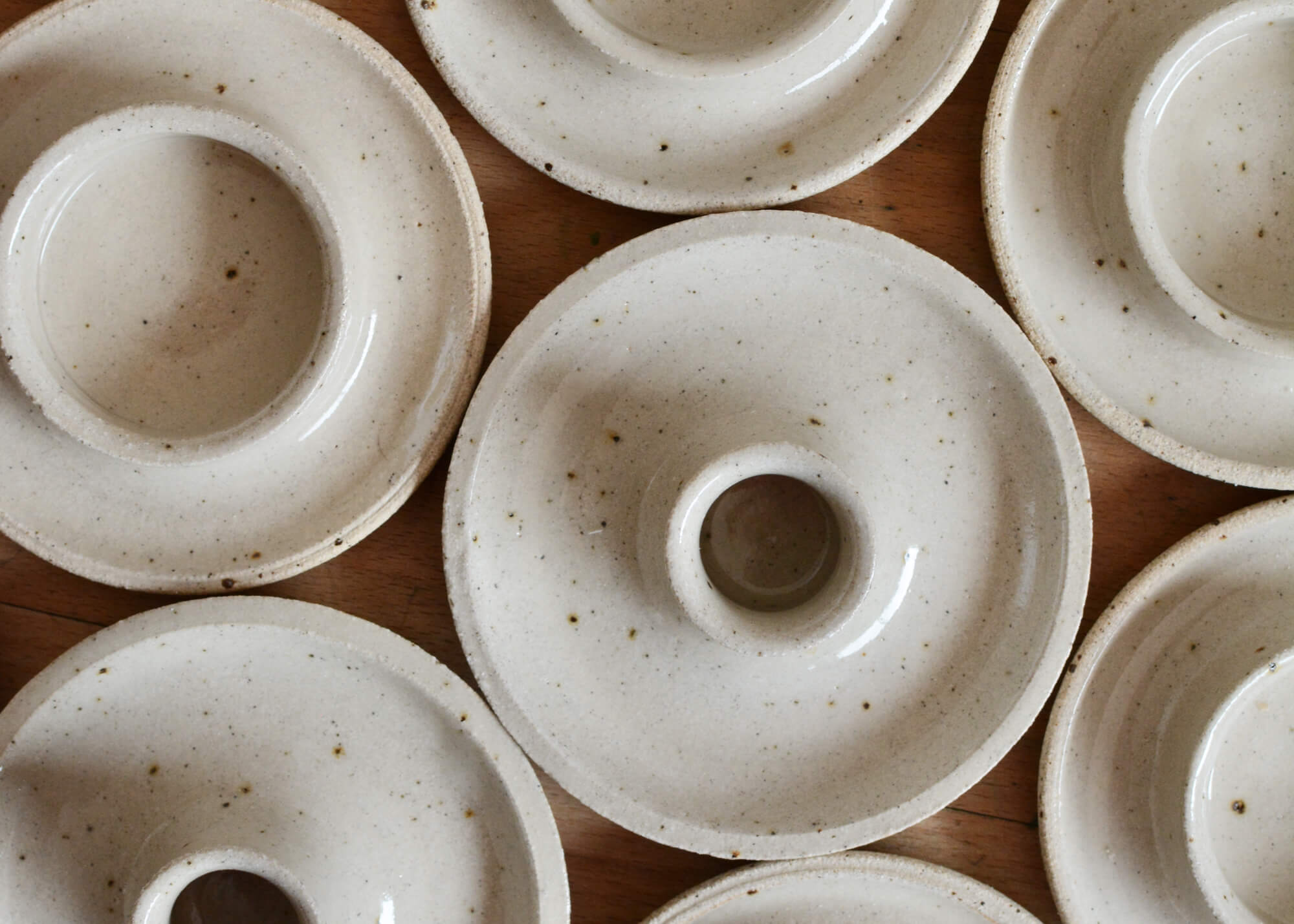 Hand thrown ceramic candle holders in a warm oatmeal colour