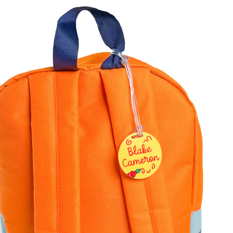 orange backpack with personalized circle bag tag sriracha hot sauce