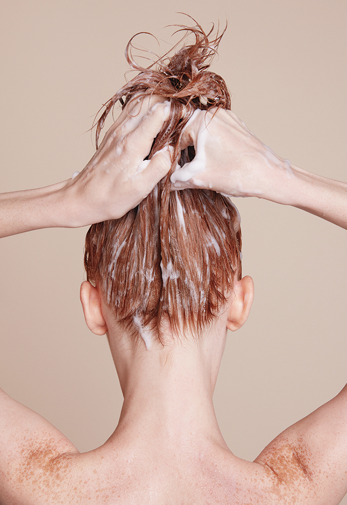 Woman Using Volumizing Shampoo For Fine Hair