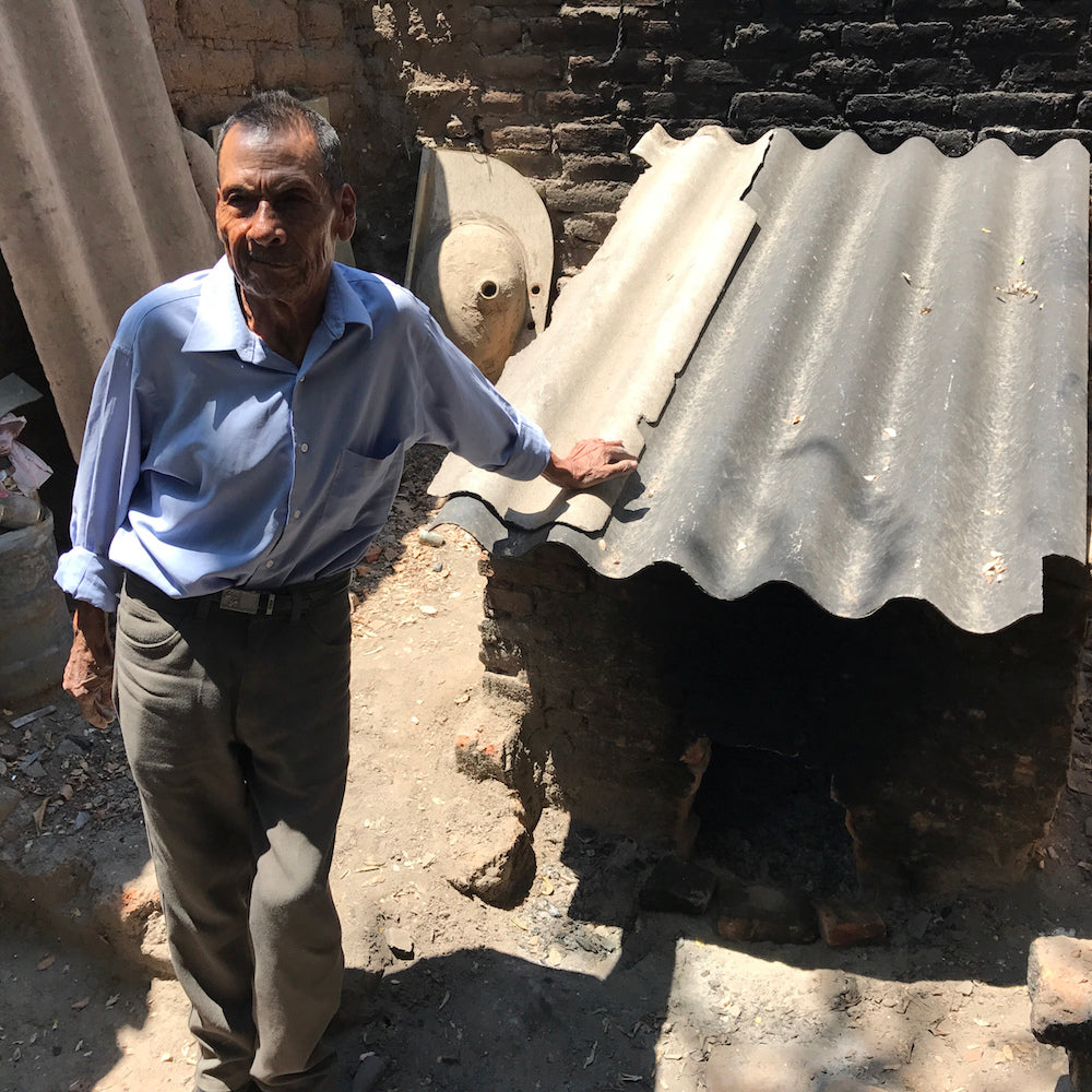 Serapio Medrano with his brick low fire kiln.