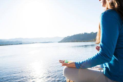 Meditate With Chakra Crystals In Hand