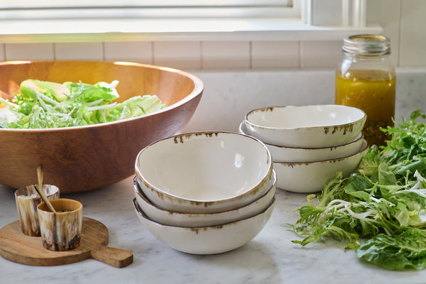 Stacks of Bare Noodle Bowls with Bronze Drip on counter