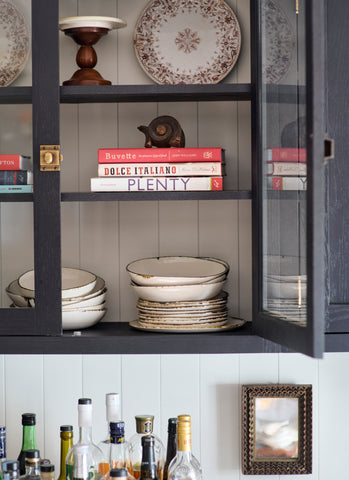 Cabinet filled with stacks of Bare Plates and Bowls