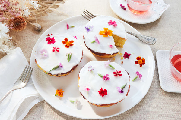 vegan cupcakes with colorful edible flowers on honeycomb salad plate
