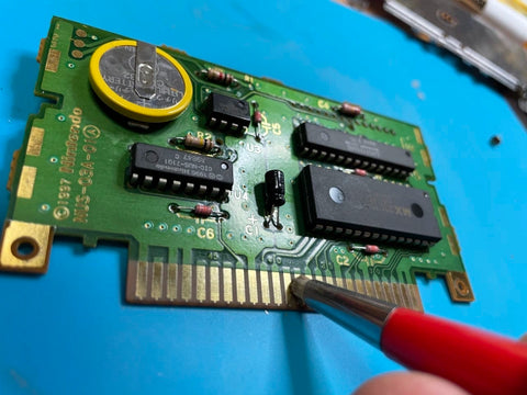 cleaning an n64 game cart with a fiberglass pen