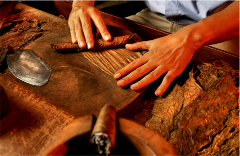 person hand wrapping a cigar