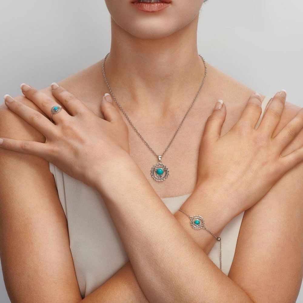Woman wearing the FIYAH throat chakra jewellery collection